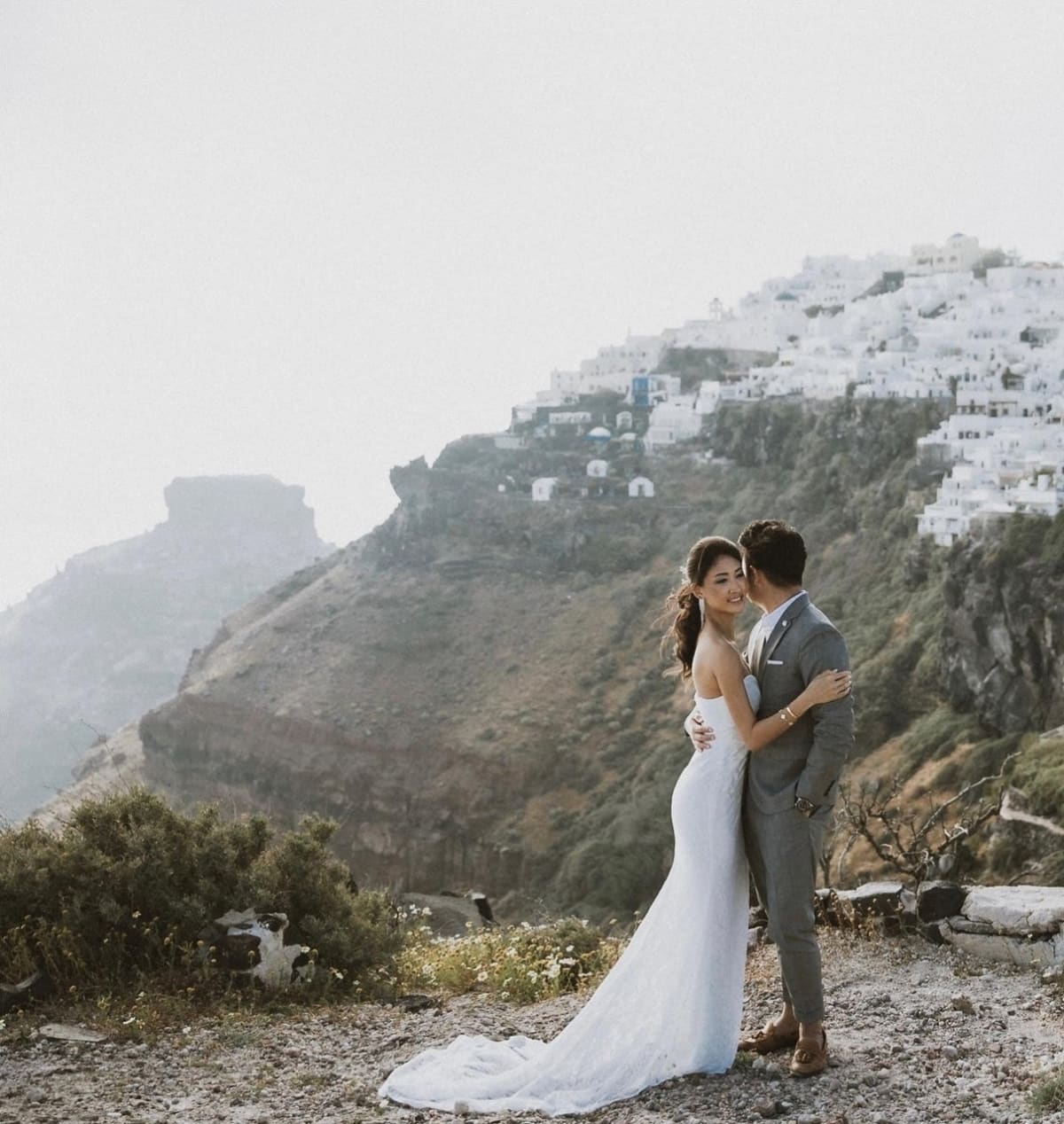 Asian bridal look with flowing fabric by the sea