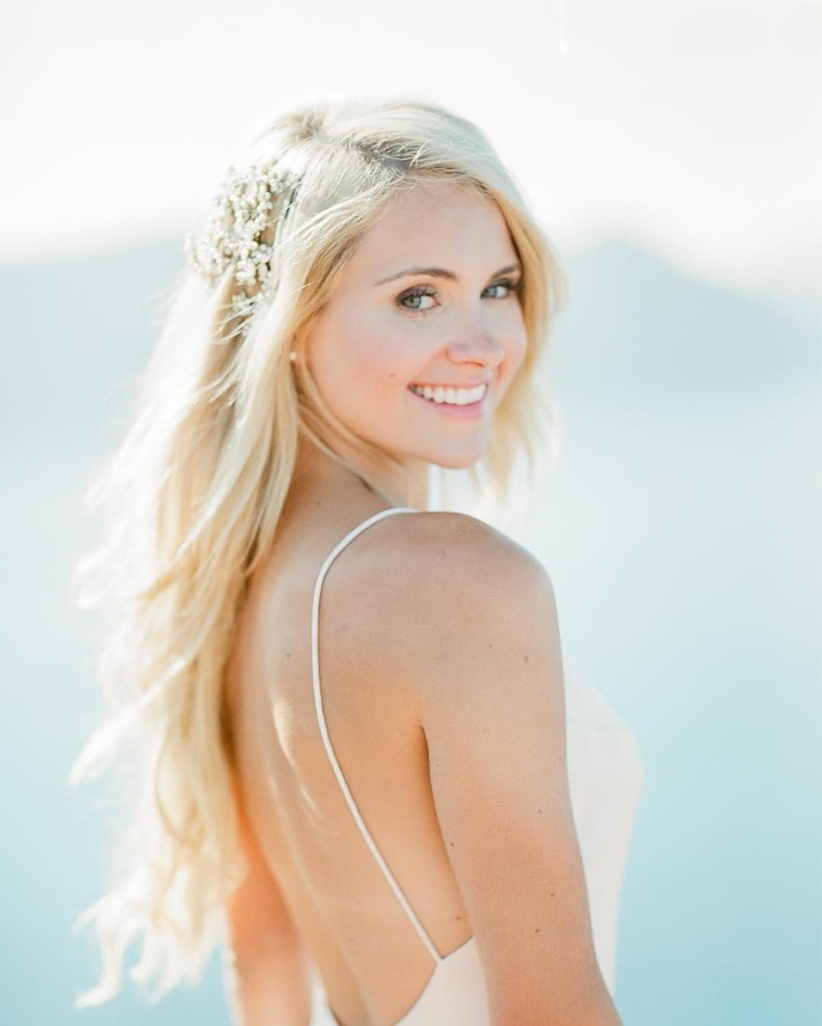 Natural blonde bride with headpiece in Santorini