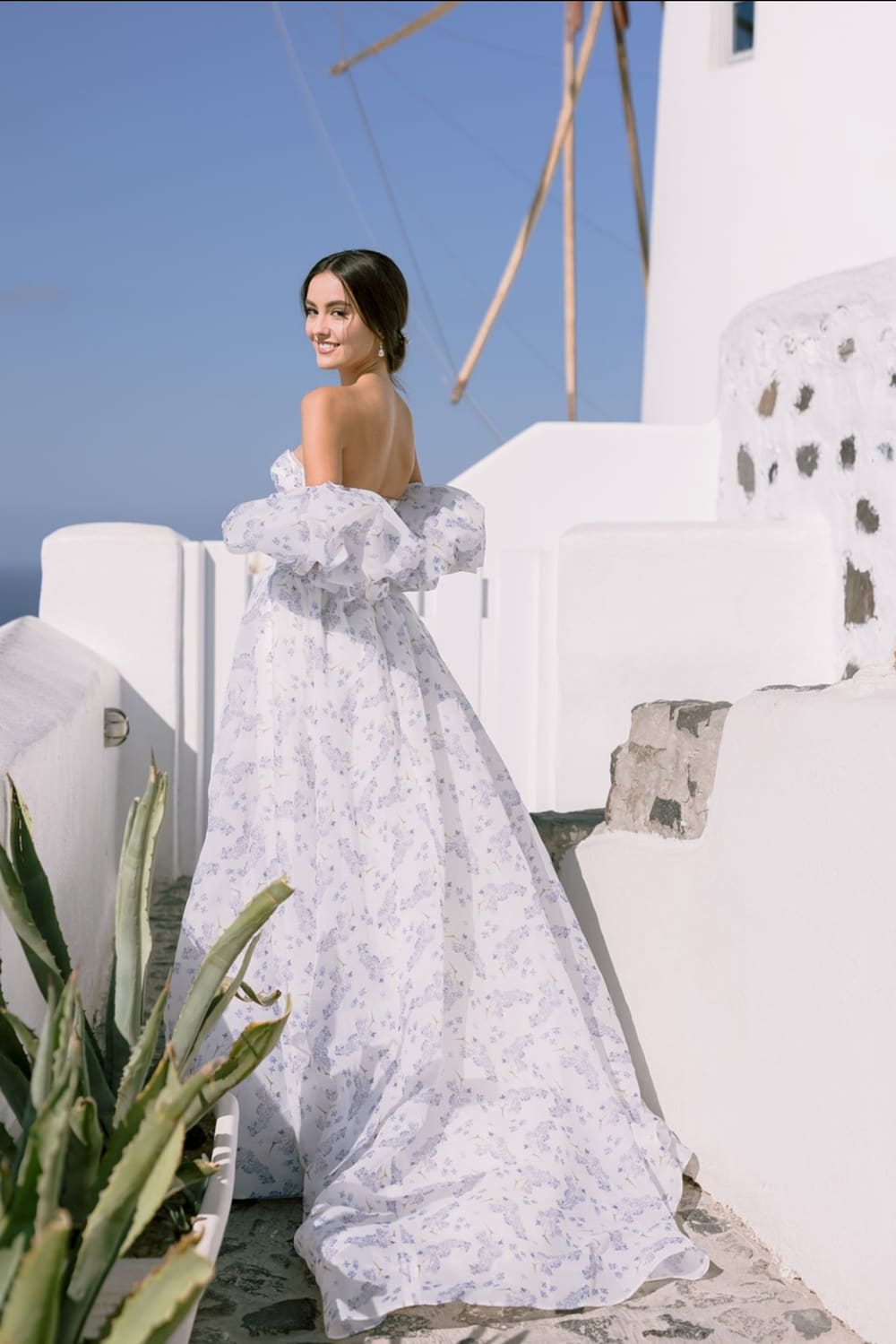 Elegant bride overlooking Oia windmill Santorini