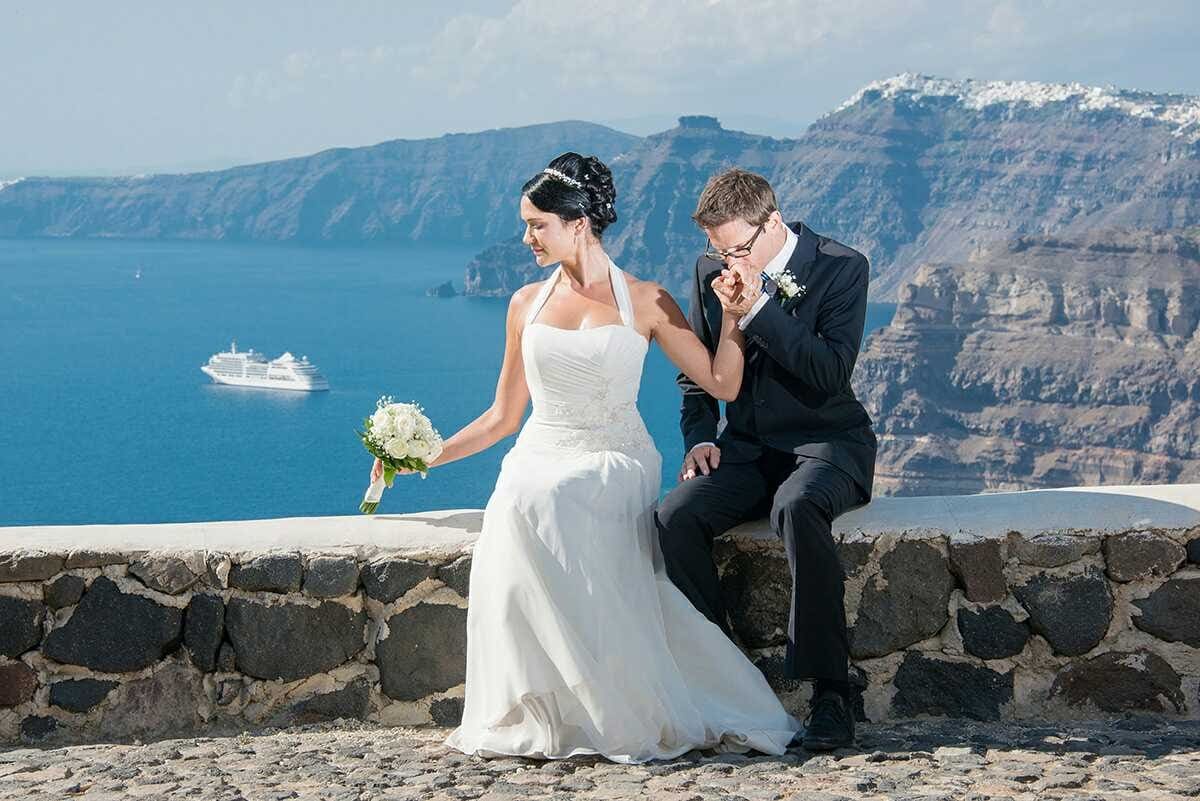 Romantic couple at Santorini caldera with cruise ship view