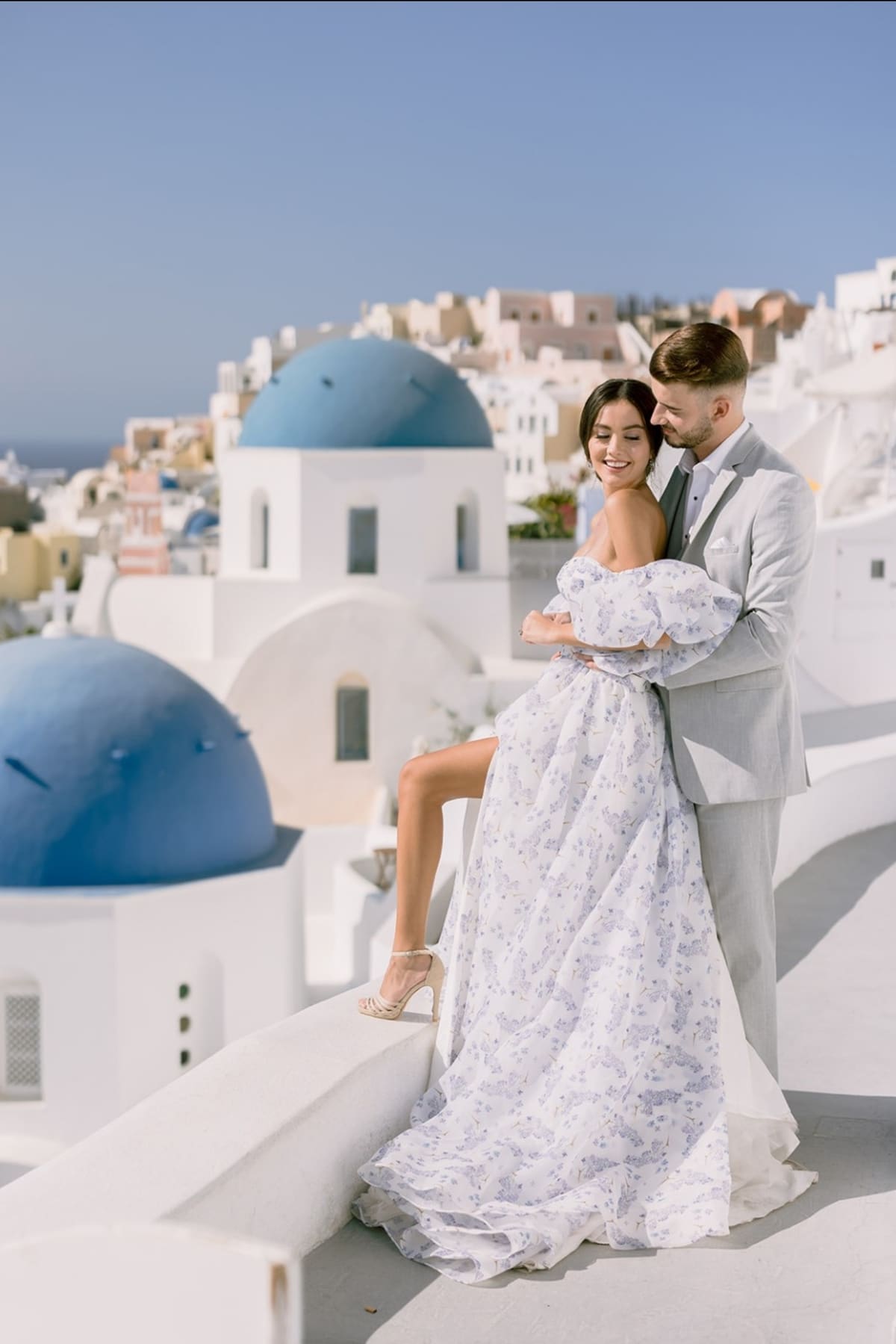 Wedding couple with blue domes backdrop in Santorini