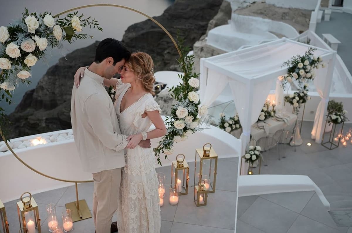 Intimate evening elopement setup with candles and florals Santorini