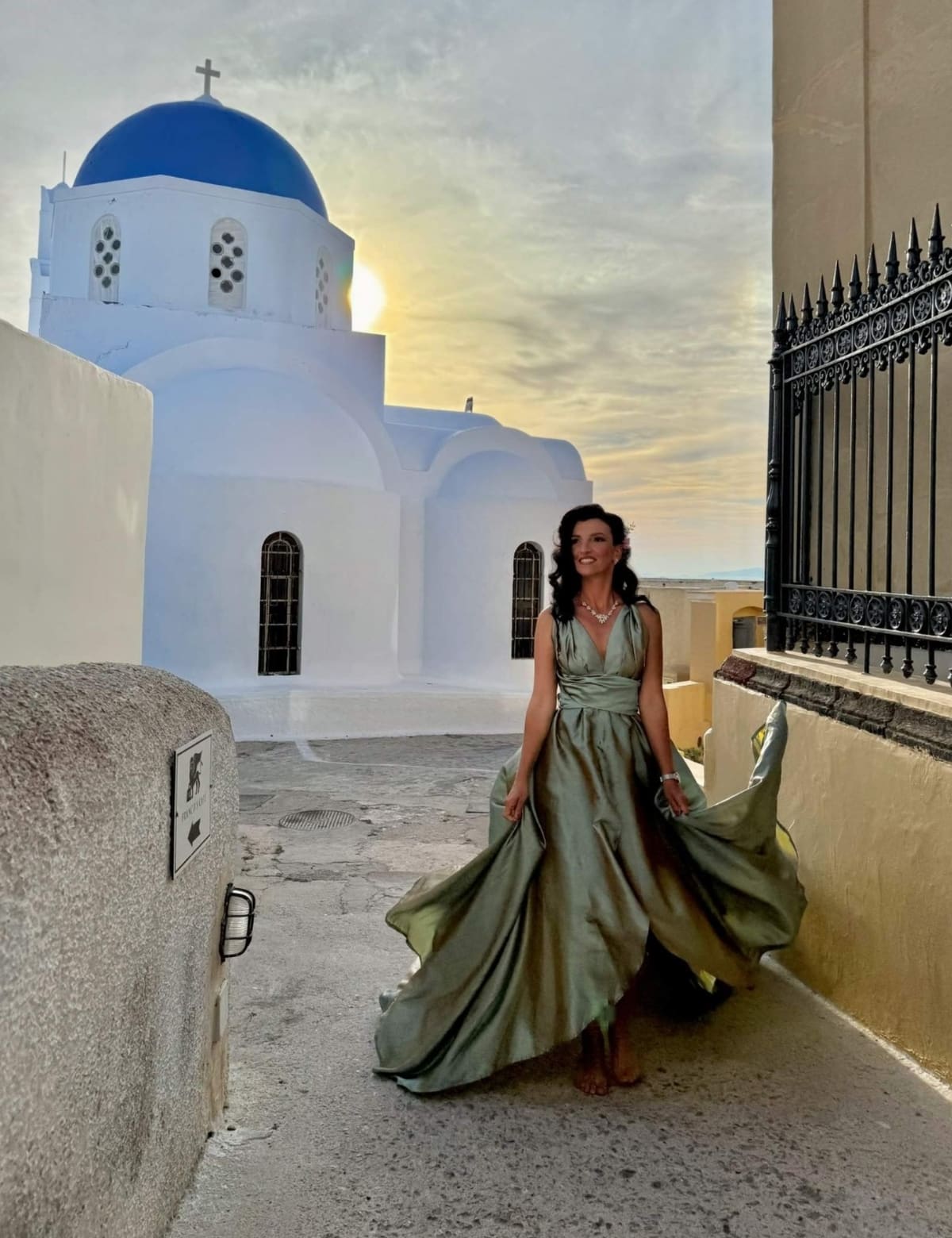 Flying dress photoshoot at Santorini blue dome church